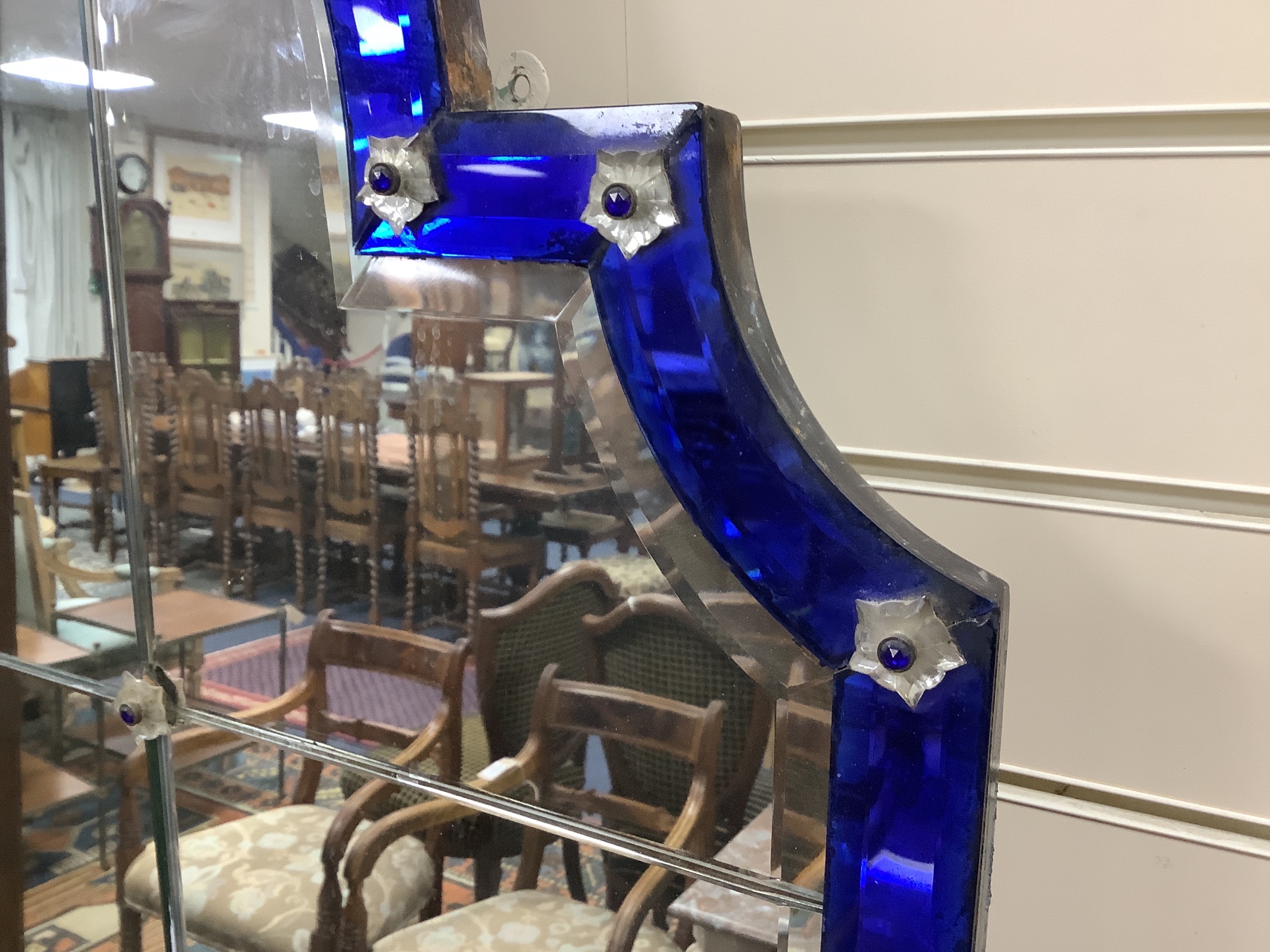 A large arched glass mirror, with blue glass borders